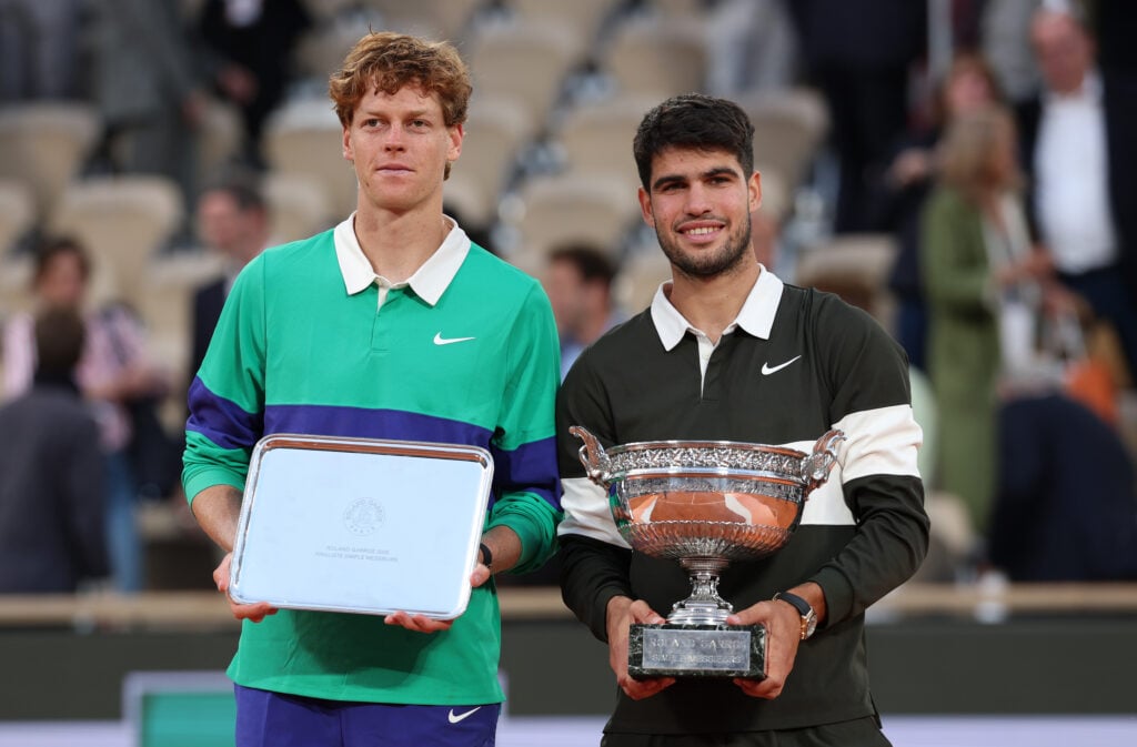 Jannik Sinner and Carlos Alcaraz pose with their trophies after the 2025 French Open final