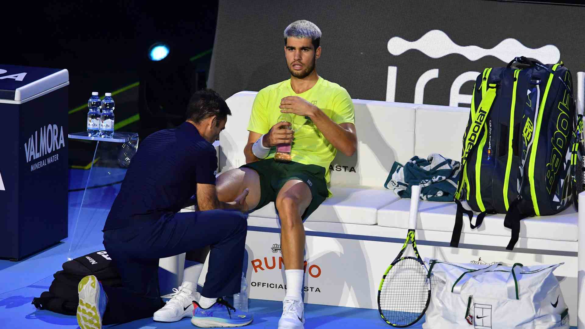 Carlos Alcaraz receives a medical timeout during Sunday's Nitto ATP Finals title match against Jannik Sinner. 