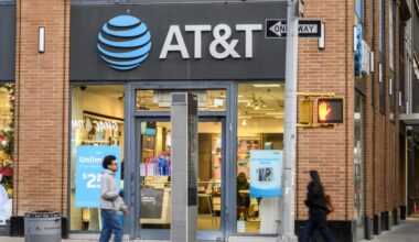 People walk on the sidewalk past an AT&T store in New York City.