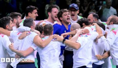 Flavio Cobolli celebrates with his team-mates after confirming Italy's Davis Cup triumph