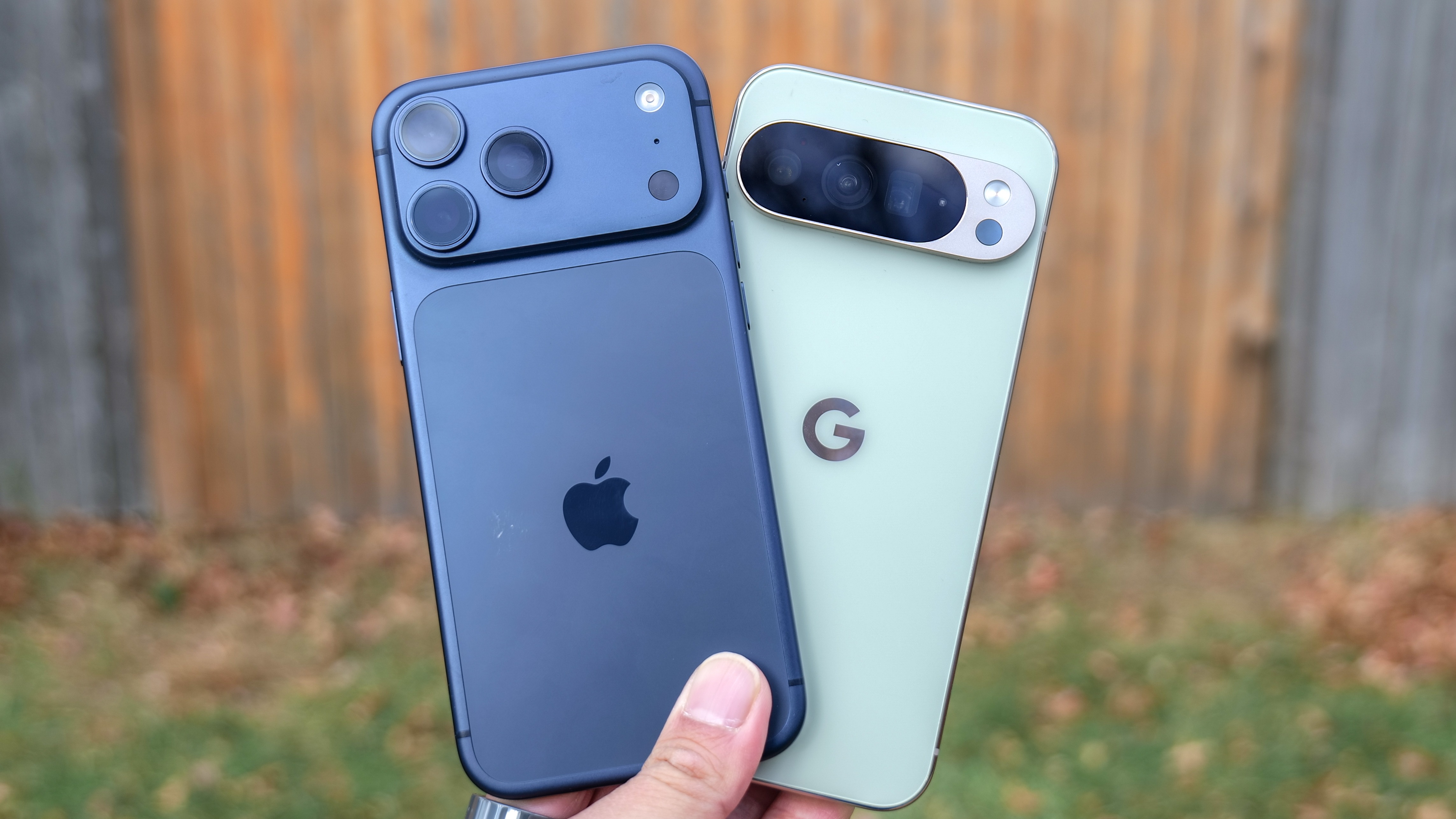 iPhone 17 Pro Max vs Pixel 10 Pro XL held in the hand.