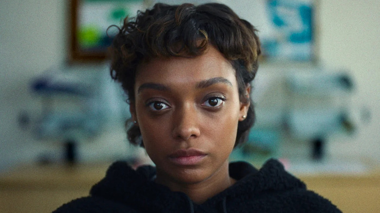 Mia (Sophie Wilde) stares ahead in class in Everything Now