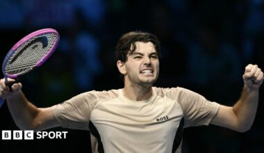 Taylor Fritz raises his arms in celebration after beating Lorenzo Musetti at the ATP Finals