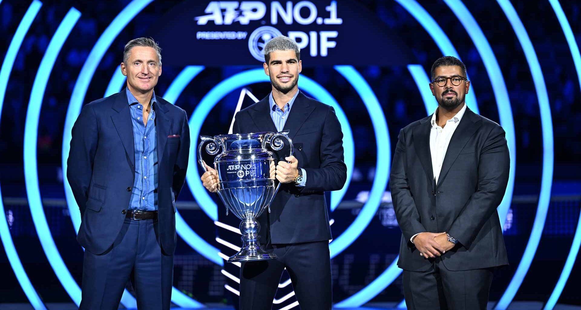 ATP Chairman Andrea Gaudenzi and Head of Corporate Brand and Strategic Advisory at PIF Mohamed Alsayyad present Carlos Alcaraz with the ATP Year-End No. 1 presented by PIF trophy.