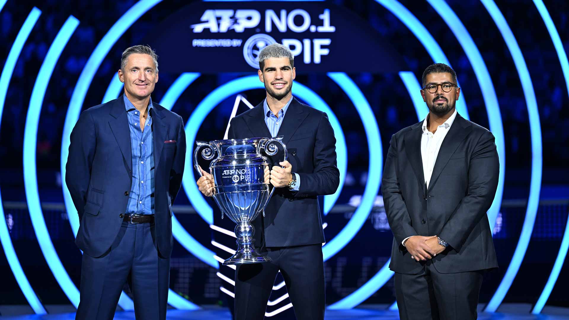 ATP Chairman Andrea Gaudenzi and Head of Corporate Brand and Strategic Advisory at PIF Mohamed Alsayyad present Carlos Alcaraz with the ATP Year-End No. 1 presented by PIF trophy.