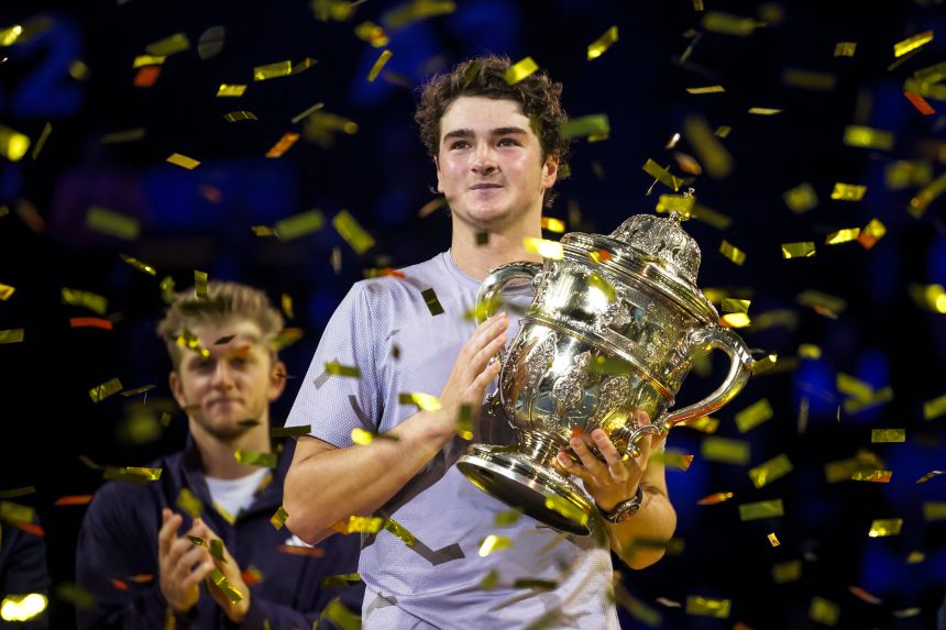 Fonseca poses with the trophy after winning the Swiss Indoors ATP 500 tournament on Sunday.