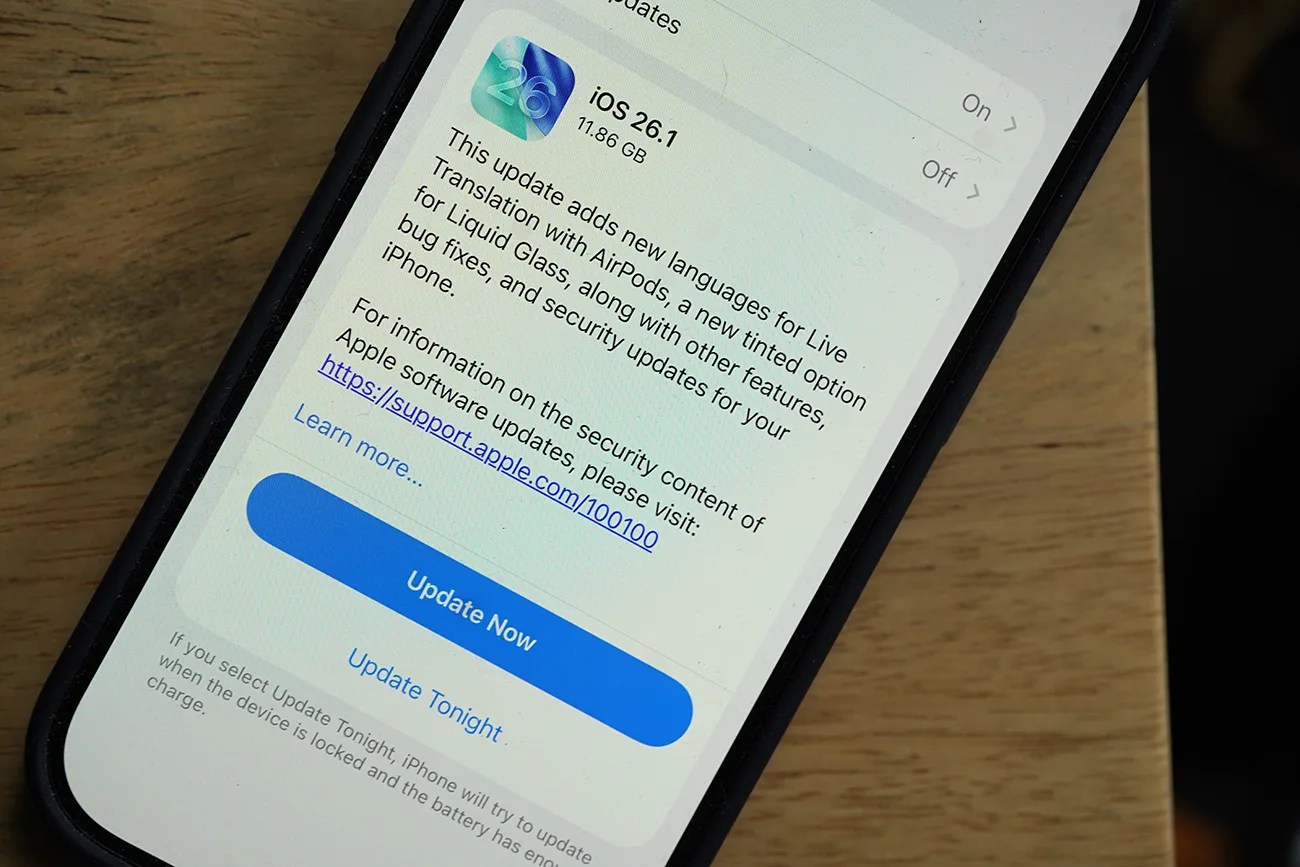 Smartphone screen showing iOS 26.1 update details with an 