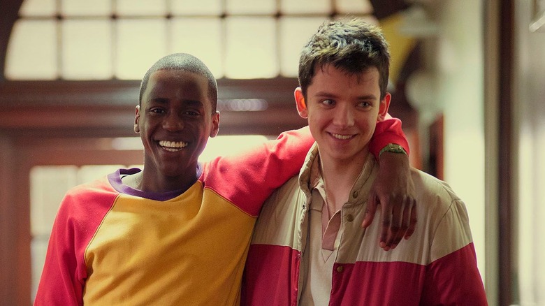 Otis (Asa Butterfield) and Eric (Ncuti Gatwa) smile in Sex Education