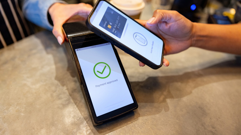 Mobile payment being made with confirmation on screen.