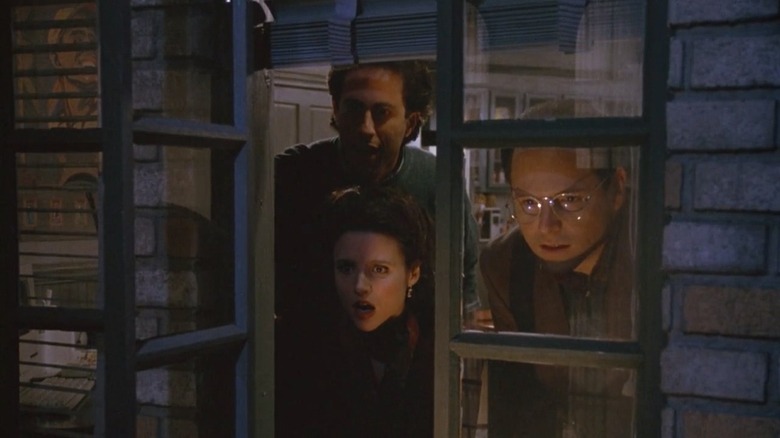 Jerry Seinfeld, Julia Louis-Dreyfus, and Jason Alexander as Jerry, Elaine, and George looking through Jerry's window in Seinfeld