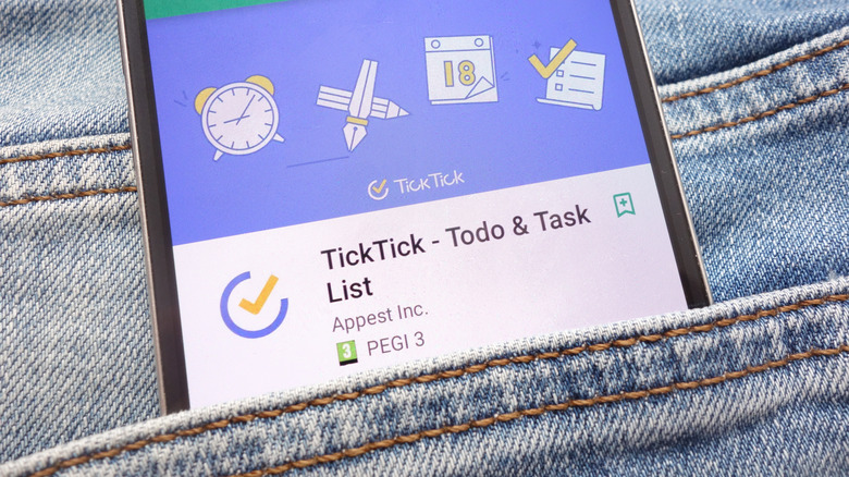A Google Android Phone sticking out from the pocket of a pair of jeans, the screen is displaying the TickTick app