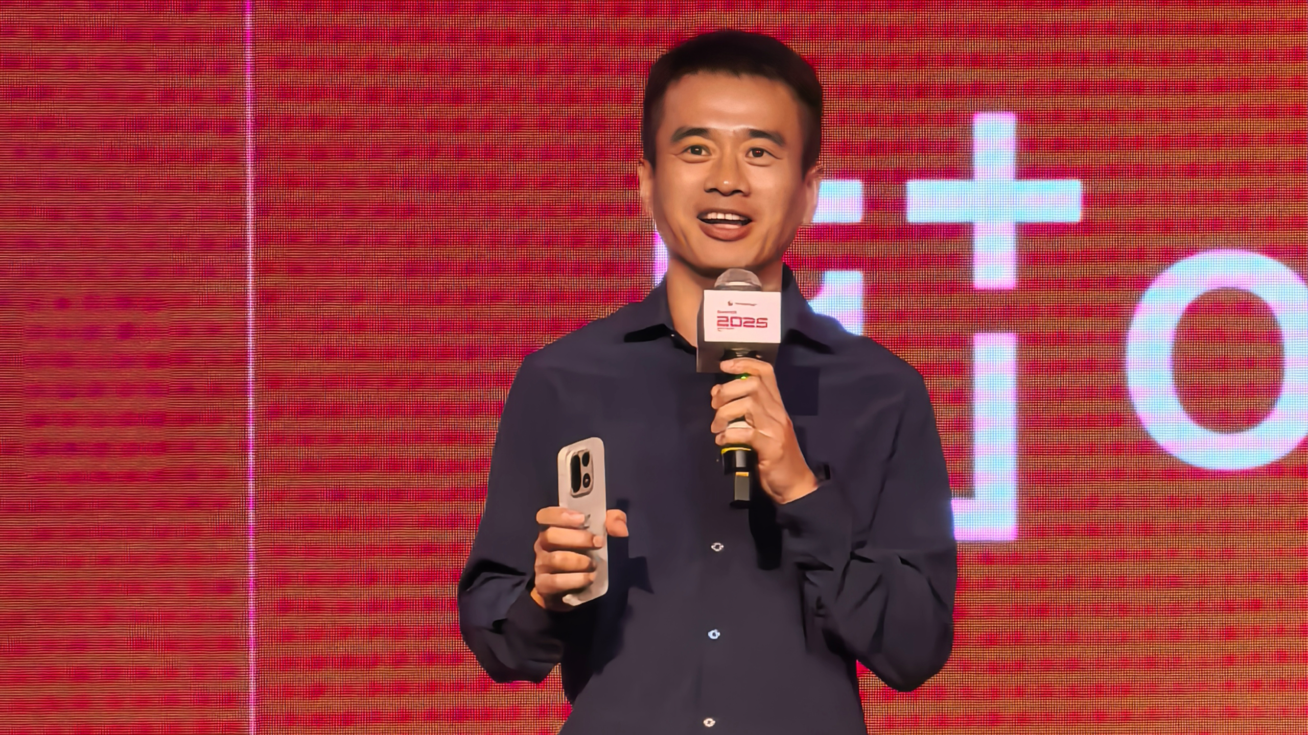 OnePlus executive holding OnePlus 15 in hand
