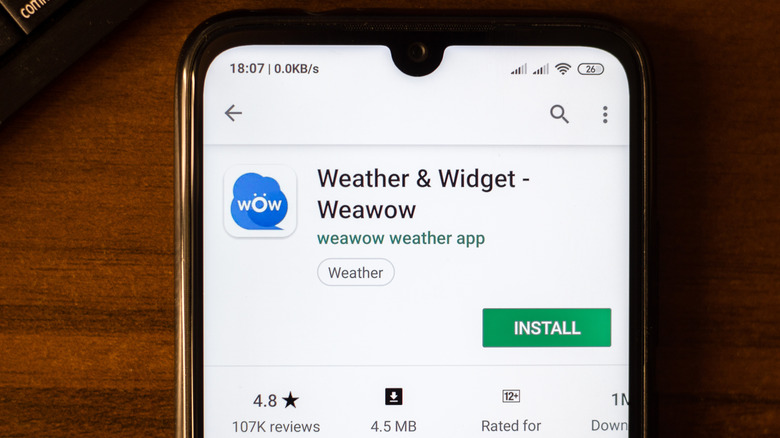 A Google Android phone displaying Weather & Widget in the Google Play Store