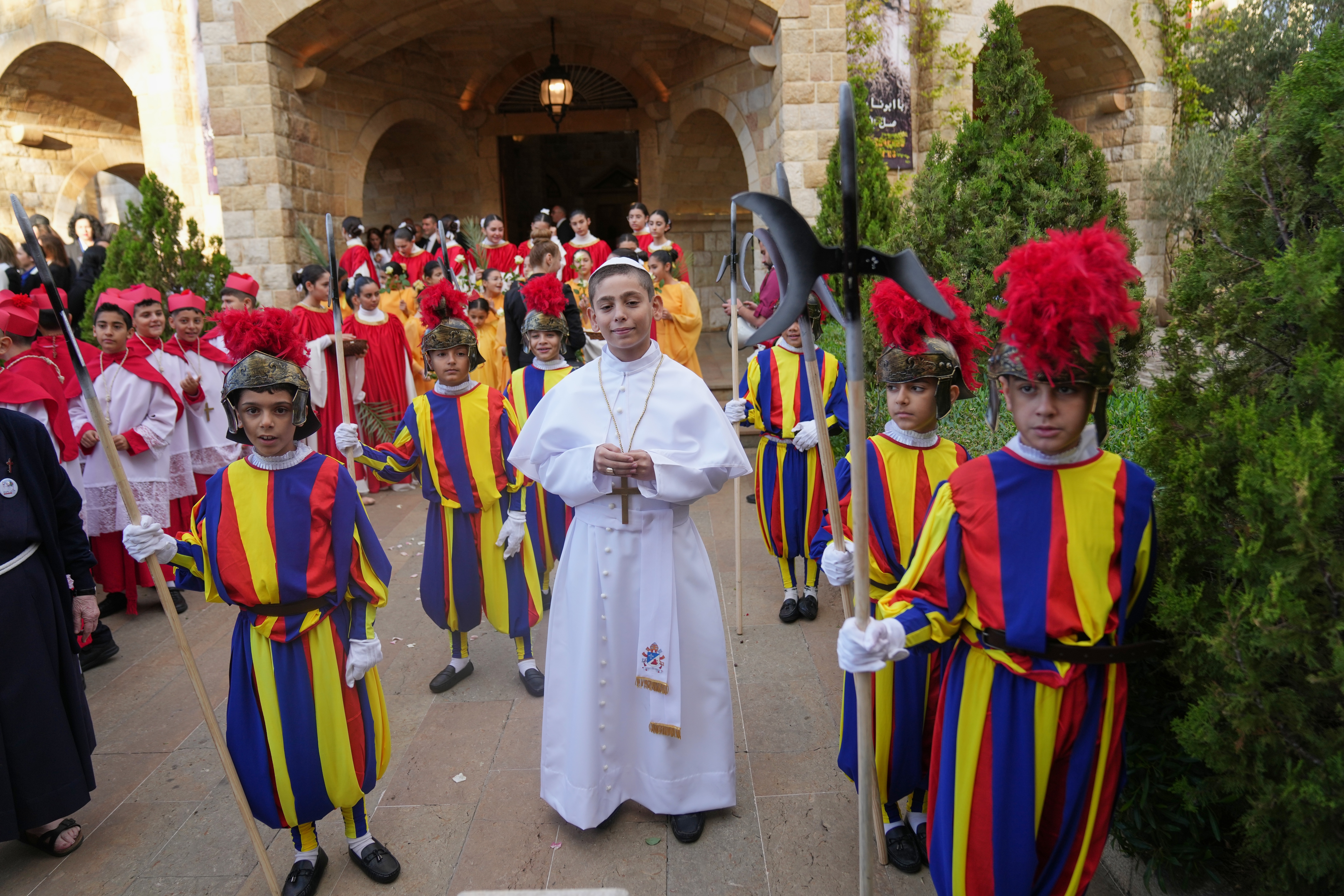 Children dressed as a pope, cardinals, and Vatican Swiss guards.