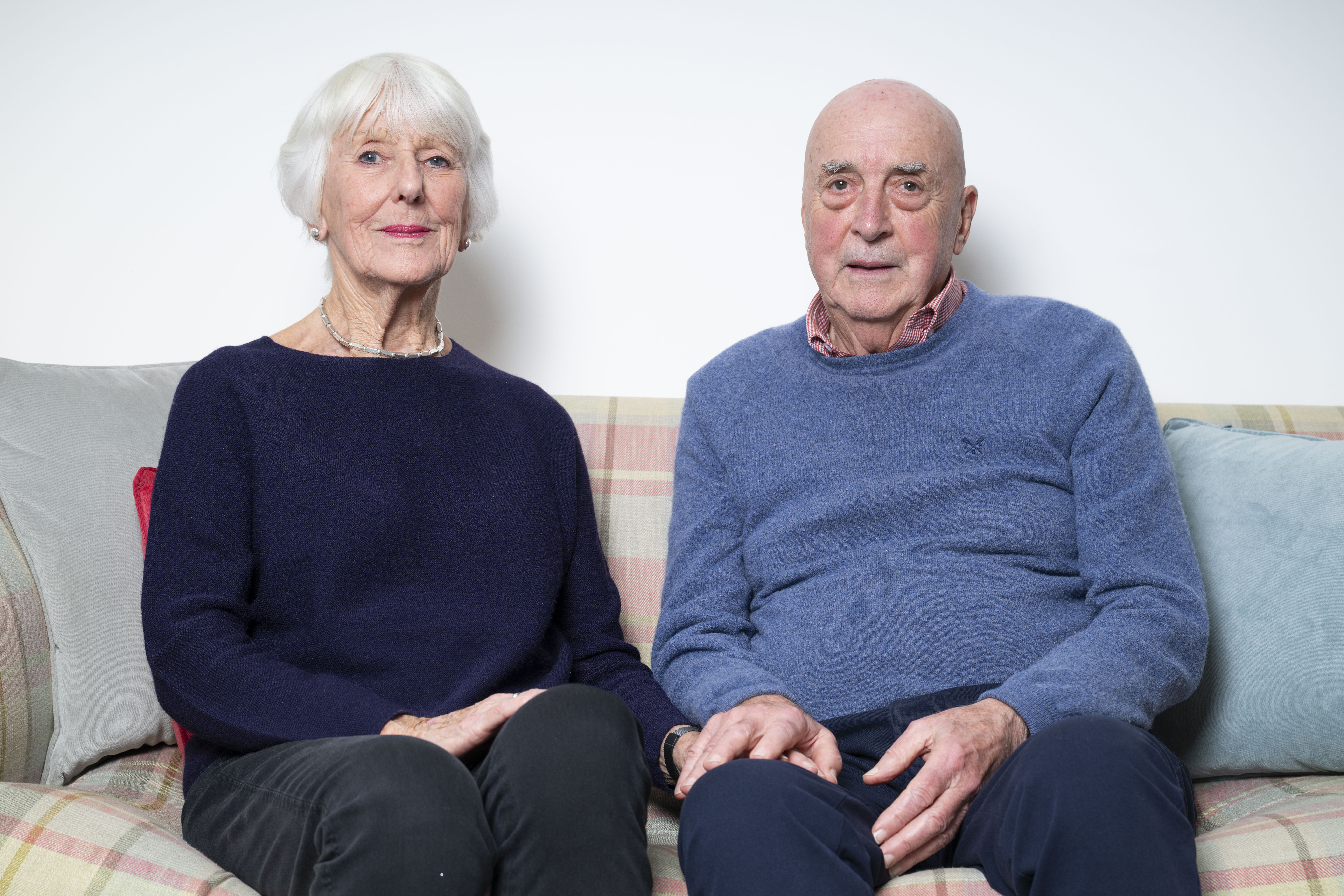 Rosie and Tony Evans, parents of Gareth Evans, sitting on a couch.