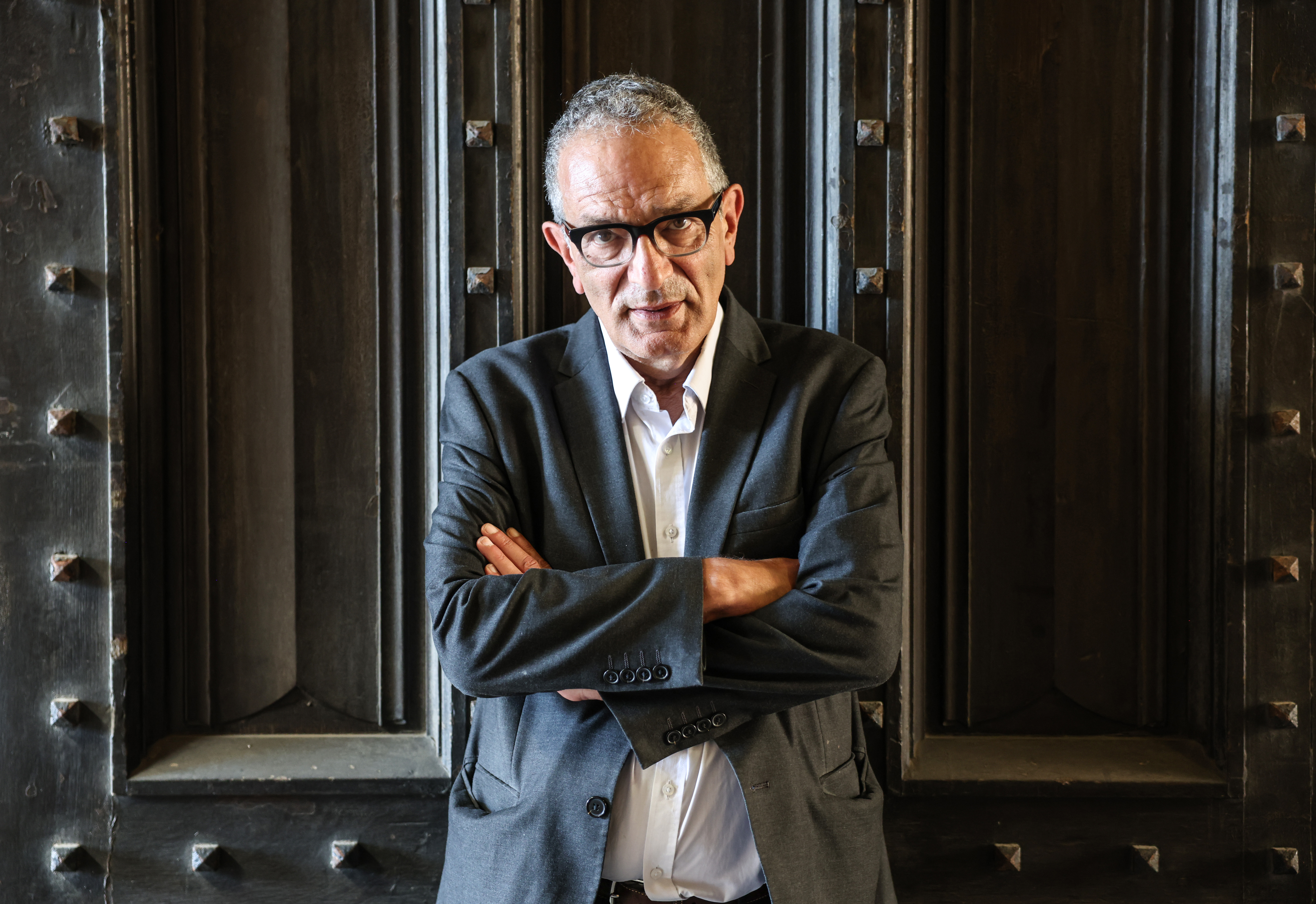 Maurice Glasman, Baron Glasman, standing with his arms crossed.