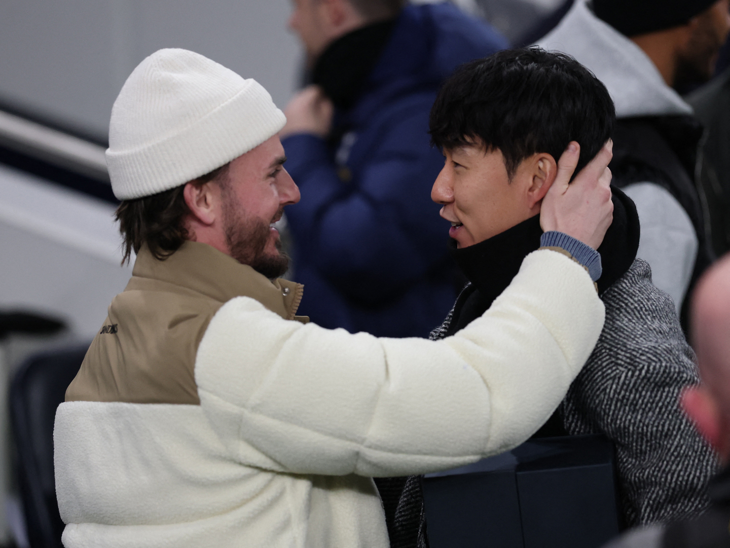 Tottenham Hotspur's James Maddison, left, and former Tottenham Hotspur player Son Heung-Min embrace before a UEFA Champions League match between Tottenham Hotspur and Slavia Prague in London on Dec. 9. [REUTERS/YONHAP]