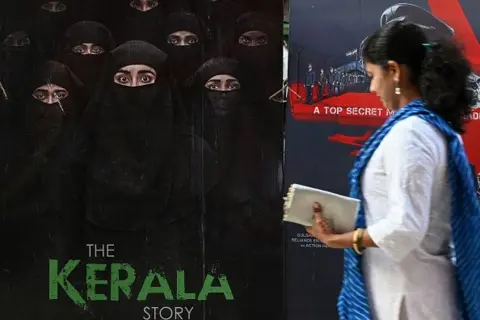 AFP via Getty Images A moviegoer walks past a poster of the film - The Kerala Story - at a movie theatre in Mumbai on May 10, 2023. The movie "The Kerala Story", accused of stoking communal hatred and propaganda against Muslims by critics has been defended strongly by the ruling right-wing Hindu government.