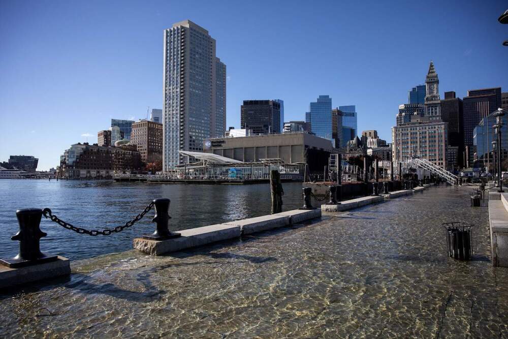 Sea water washes across parts of Long Wharf during a king tide last November. (Robin Lubbock/WBUR)
