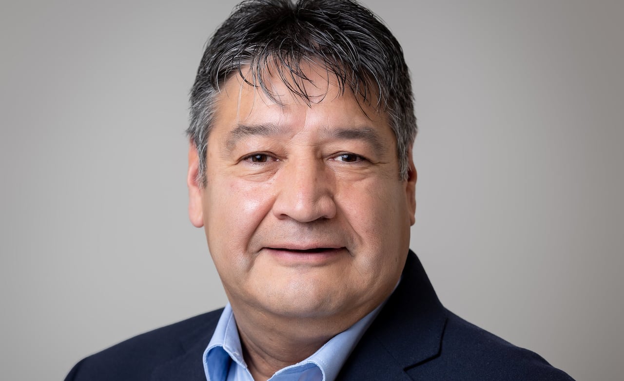 A man poses for a headshot.