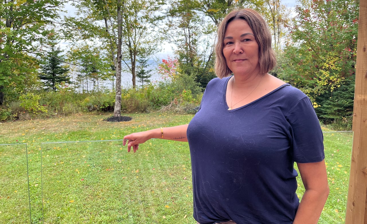 Woman standing next to clear railing