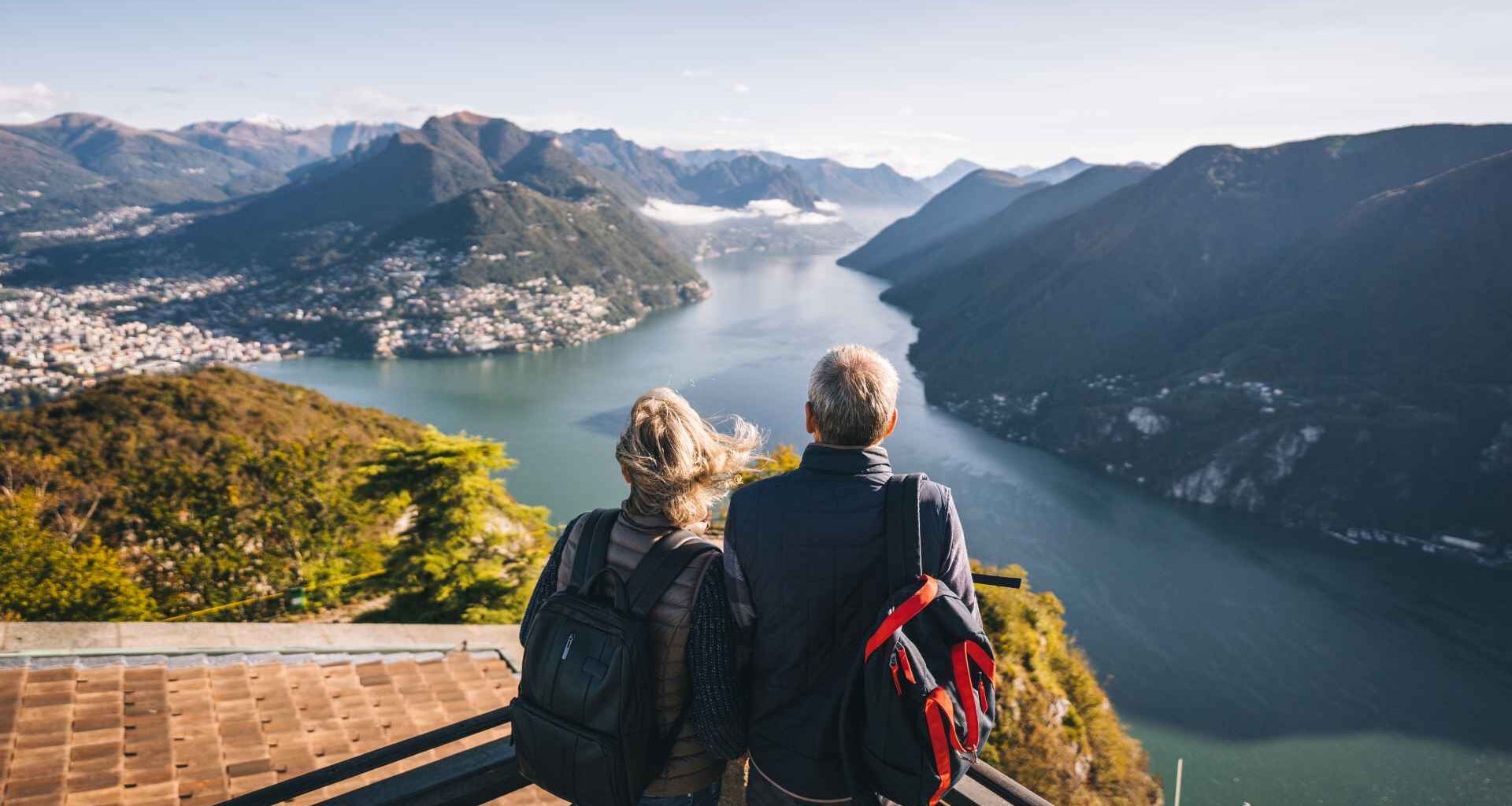They relax at viewpoint and look off to distant scene.