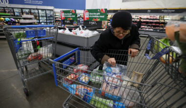FILE PHOTO: Customers shop for groceries in Walmart Supercenter retail store in North Bergen, New Jersey