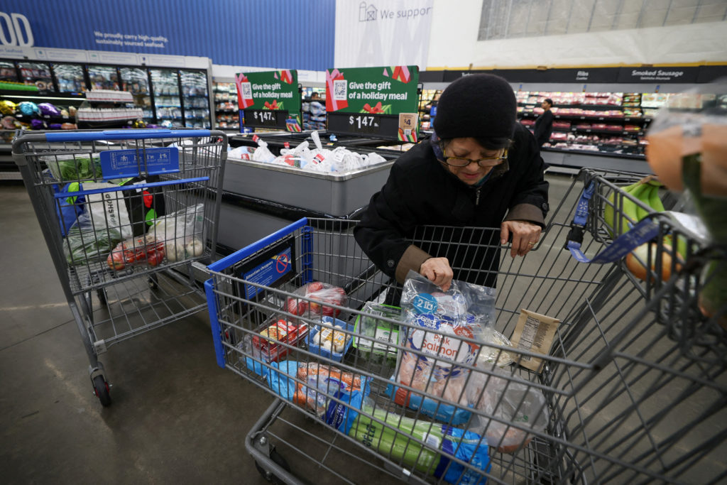 FILE PHOTO: Customers shop for groceries in Walmart Supercenter retail store in North Bergen, New Jersey