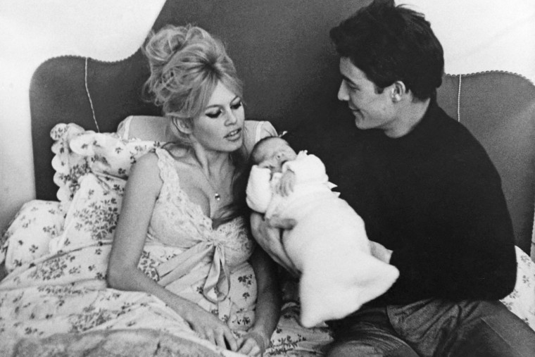 Brigitte Bardot and her husband, Jacques Charrier, with their son, Nicolas, in 1960.      