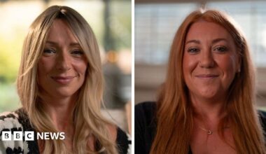 Two women are smiling at the camera, the one on the left, Ellen, has long blonde hair. The one on the right, Tanya, has long red hair