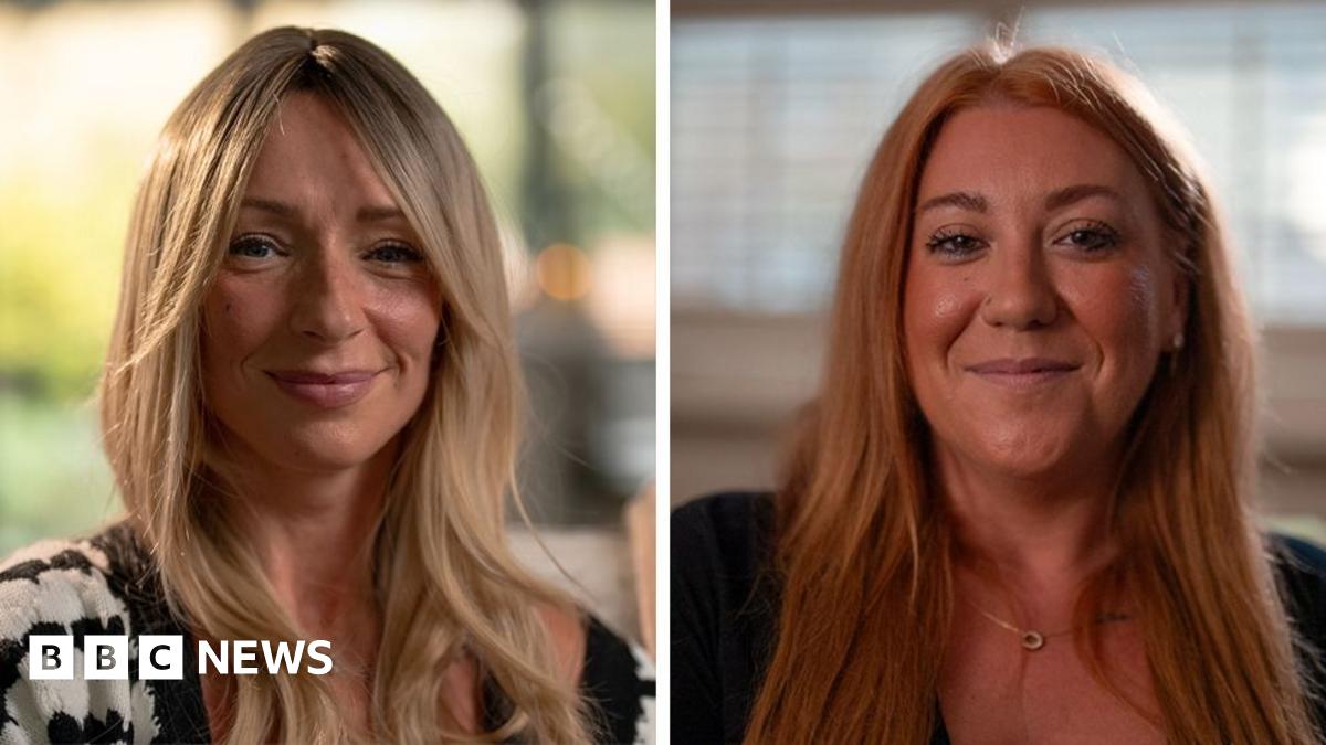 Two women are smiling at the camera, the one on the left, Ellen, has long blonde hair. The one on the right, Tanya, has long red hair