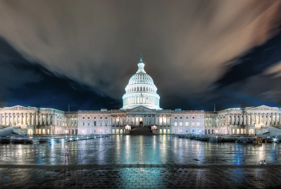 The U.S. Capitol building at night, with dramatic clouds and lighting enhancing its grand architecture