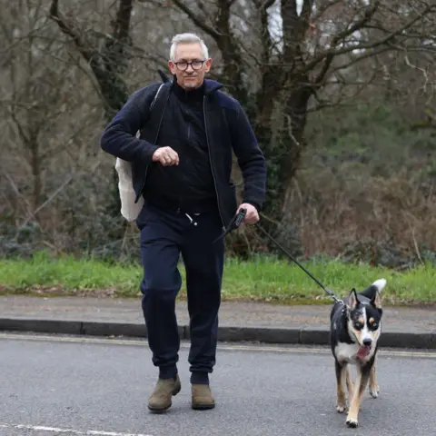 Hollie Adams/Getty Images Gary Lineker on a road walking his dog