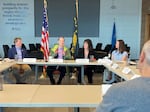 Sen. Ron Wyden (center) discusses the affects of tariffs with Trey Winthrop, CEO of Bob’s Red Mill (left), Tia Sandberg, president of Columbia River Customs Brokers & Forwarders Association (right), and Erica Mitchell, chief financial officer at Hood River Distillers, and others at the Port of Portland on April 21, 2025.