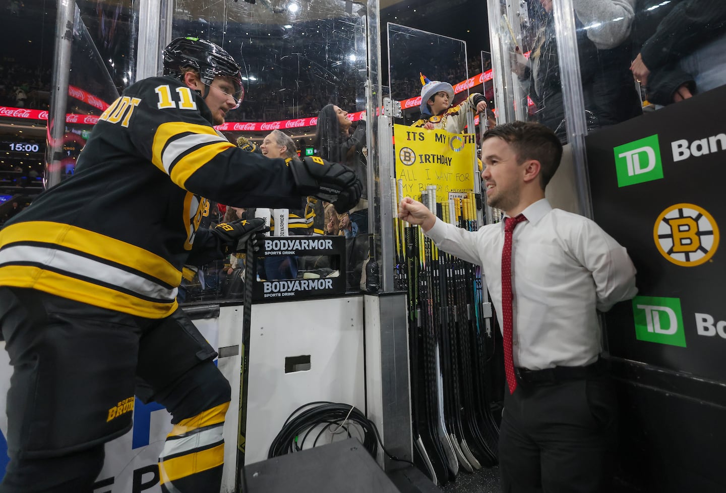 Bruins video coordinator Mat Myers (right) gives a high five to Casey Mittelstadt after pregame warm-up before facing the Canucks at TD Garden on December 20.