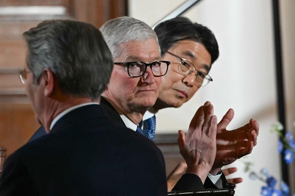 Apple CEO Tim Cook (C) applauds as US President Donald Trump delivers a speech to business leaders at the US ambassador's residence in Tokyo on October 28, 2025. (Photo by ANDREW CABALLERO-REYNOLDS / AFP) (Photo by ANDREW CABALLERO-REYNOLDS/AFP via Getty Images)          