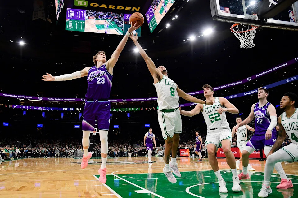 Nov 3, 2025; Boston, Massachusetts, USA; Utah Jazz forward Lauri Markkanen (23) and Boston Celtics forward Josh Minott (8) battle for a loose ball during the second half at TD Garden. Mandatory Credit: Bob DeChiara-Imagn Images