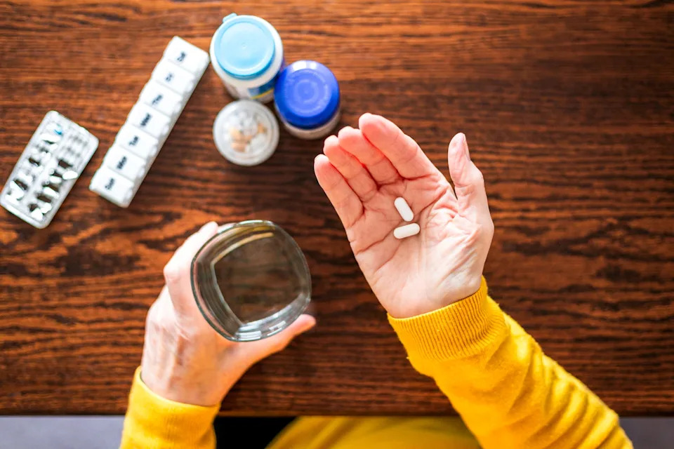 Woman holding two pills