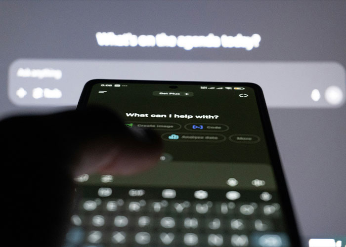 A close-up of a smartphone screen showing ChatGPT interface with a blurred keyboard and user interaction.