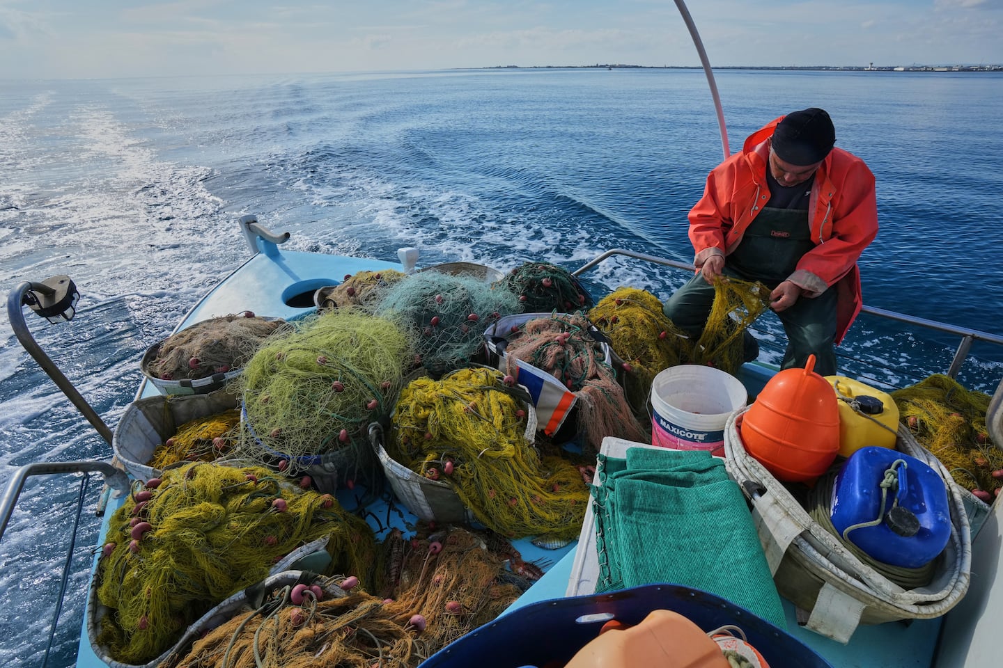 Fisherman Photis Gaitanos collected fish from nets off the coast of Larnaca, Cyprus, in the eastern Mediterranean, on Dec. 20.