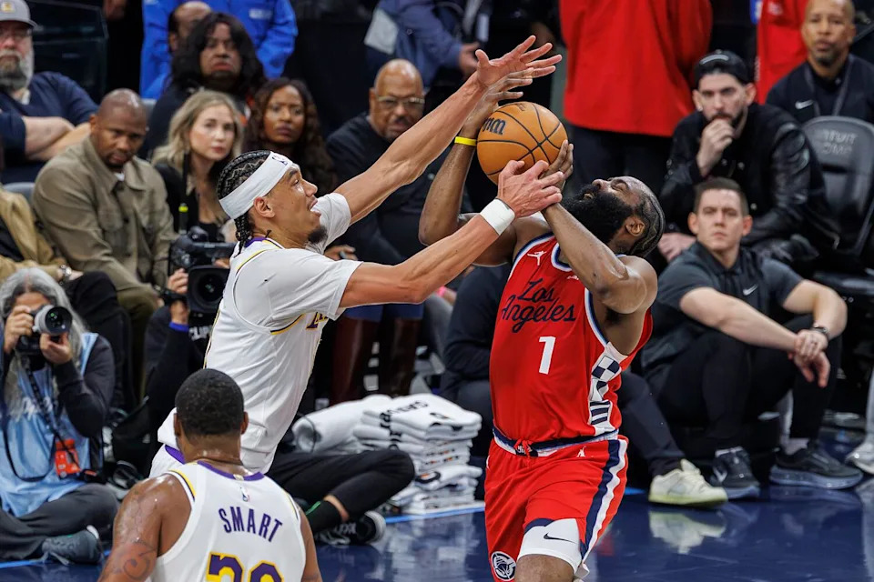 Lakers center Jaxson Hayes, left, foulds Clippers guard James Harden on a layup.