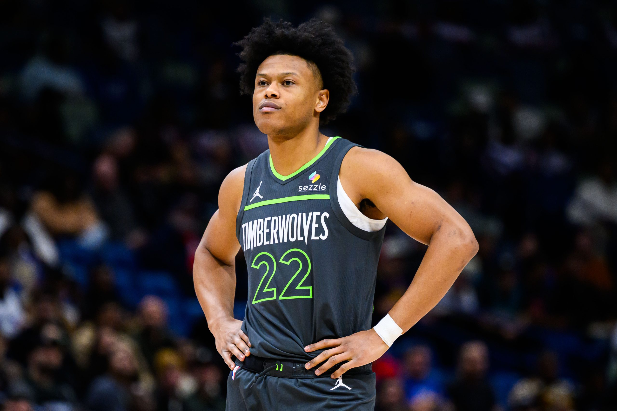 a basketball player has his hands on his hips