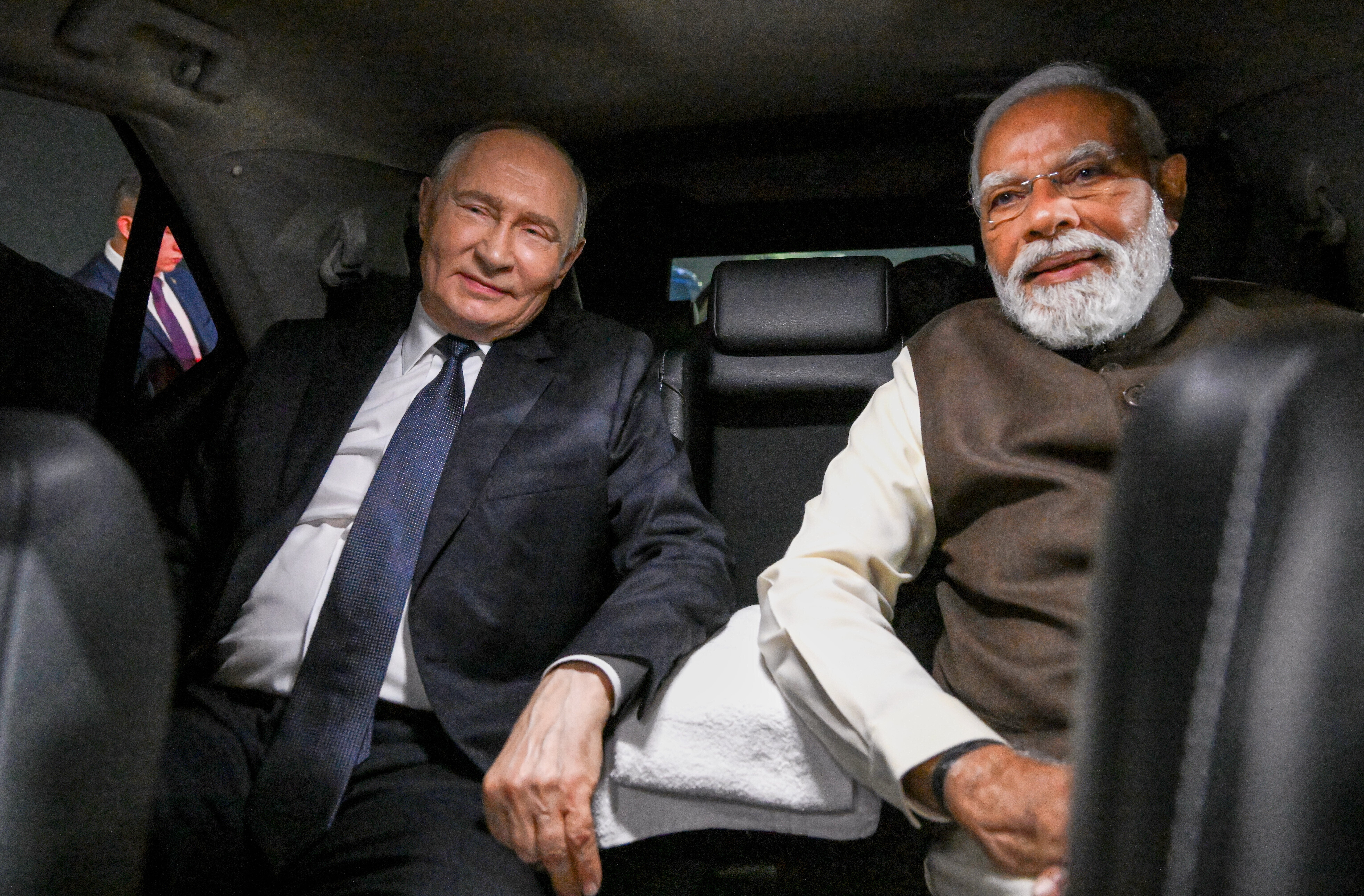 Russian president Vladimir Putin and Indian prime minister Narendra Modi sit inside a limousine after arriving at the Palam Air Base in New Delhi
