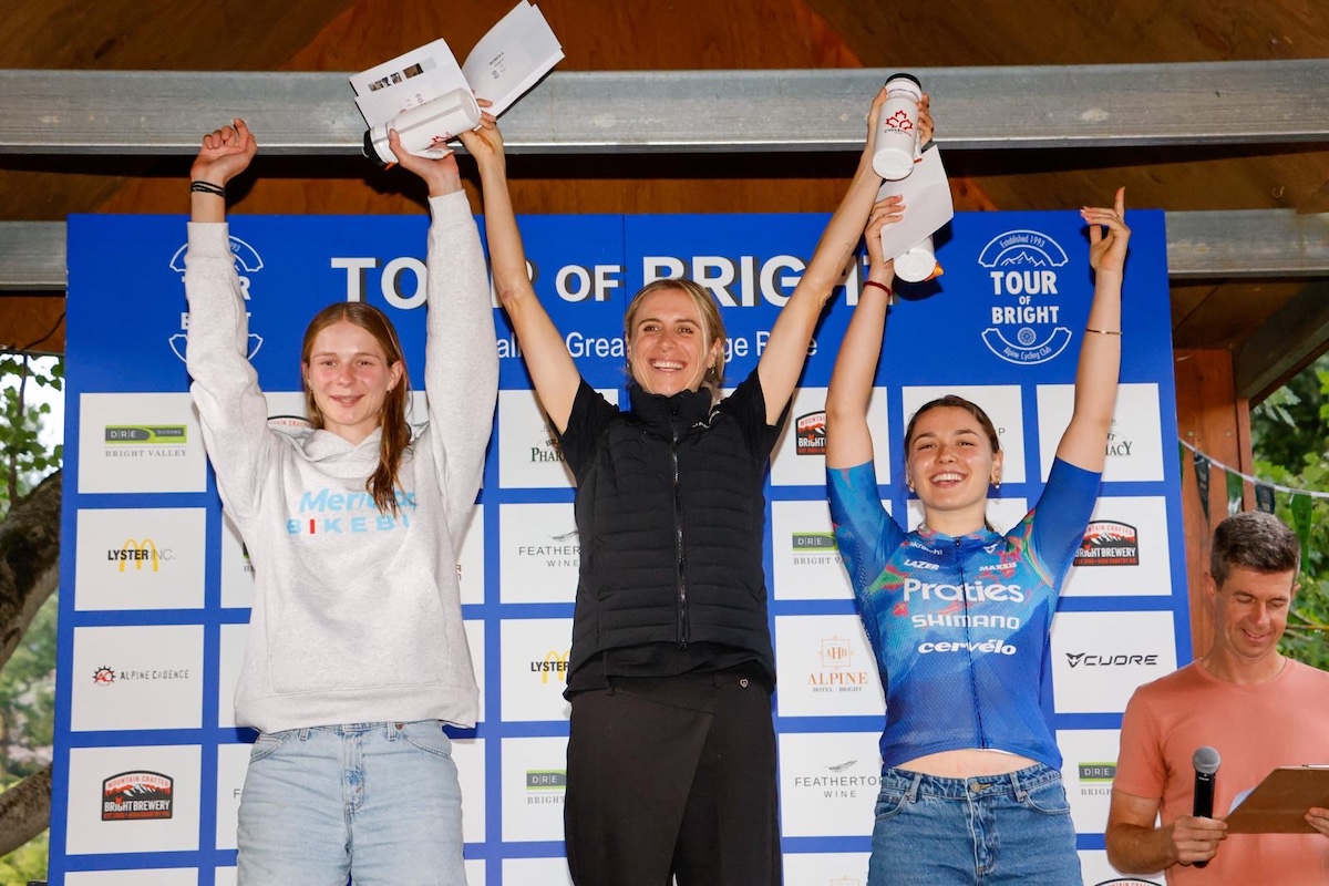 Kirsty Watts (Meridian Blue p/b 99 Bikes) stands on the ITT podium of the Tour of Bright in second, with Brodie Chapman (UAE Team ADQ) first and Sophie Marr (Praties) in third