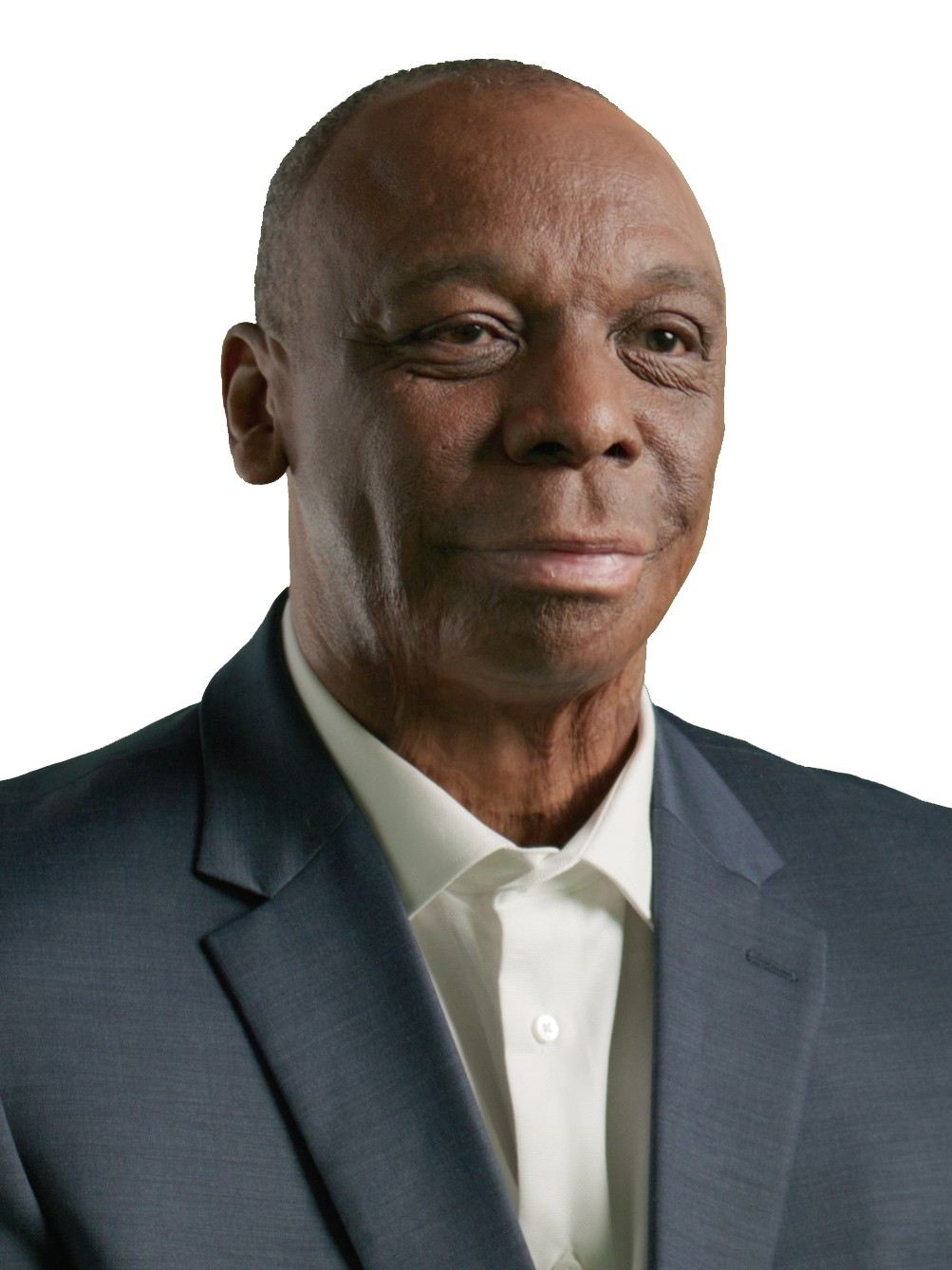a photo of a smiling man wearing a suit jacket and white shirt
