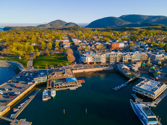 Bar Harbor, Maine with Cadillac Mountain and Acadia National Park in the background Bar Harbor, Maine with Cadillac Mountain and Acadia National Park in the background