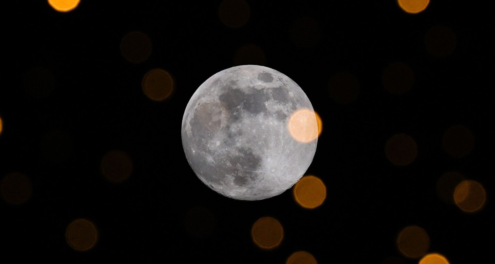 The full moon pictured glowing in the night sky.