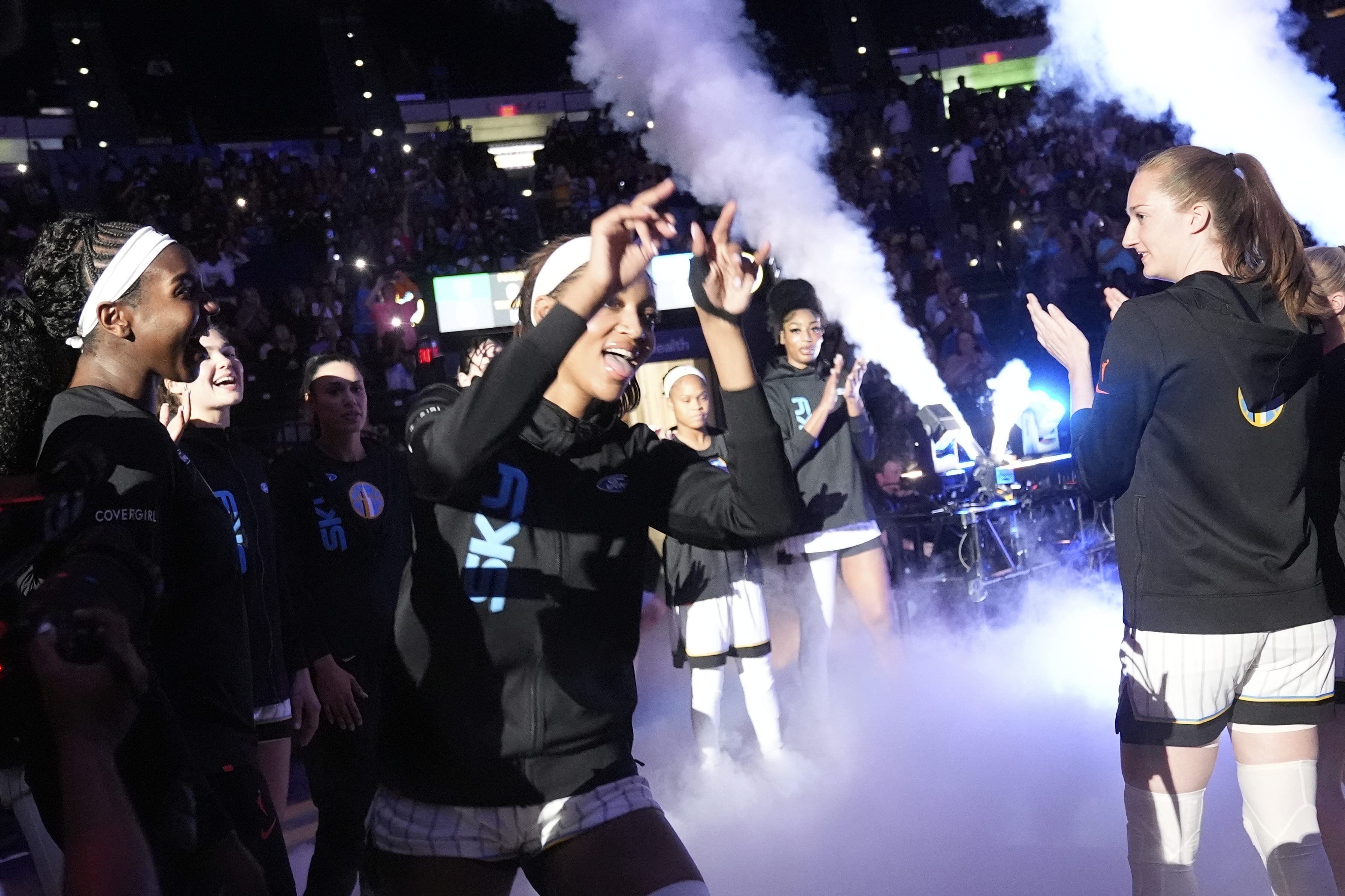 Sky forward Angel Reese greets teammates as she is introduced...