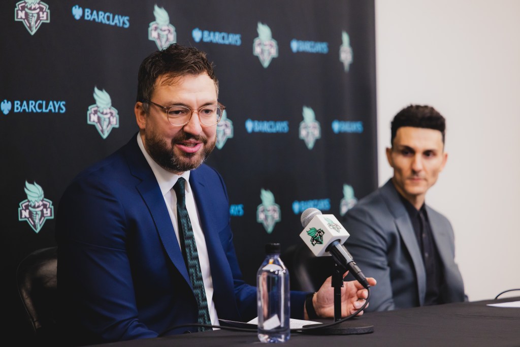 Chris DeMarco answers a question in the Liberty's press conference room while sitting alongside General Manager Jonathan Kolb