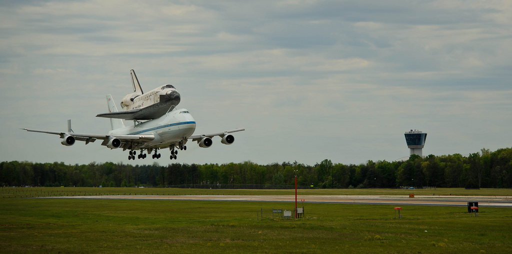 Space Shuttle Discovery mounted atop a 747 Shuttle Carrier Aircraft (SCA) approaches the runway for landing at Washington Dulles International Airport, Tuesday April 17, 2012, in Sterling, Va.
